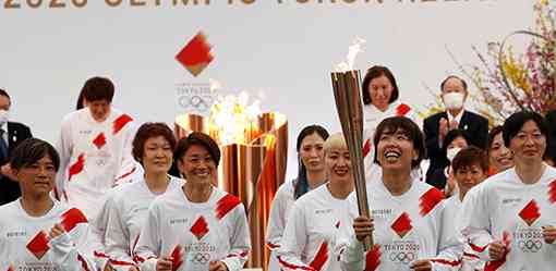 Waves, smiles but no cheers as Olympic torch relay kicks off under pandemic shadow