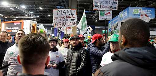 Angry French farmers storm into agriculture fair in Paris