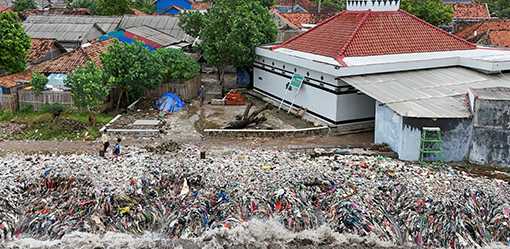 Indonesia fishing village grapples with piles of trash brought in by tides