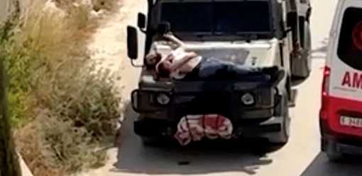 Israeli forces strap wounded Palestinian to jeep during raid