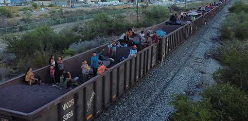 Mexican officials push migrants away from border-bound cargo trains