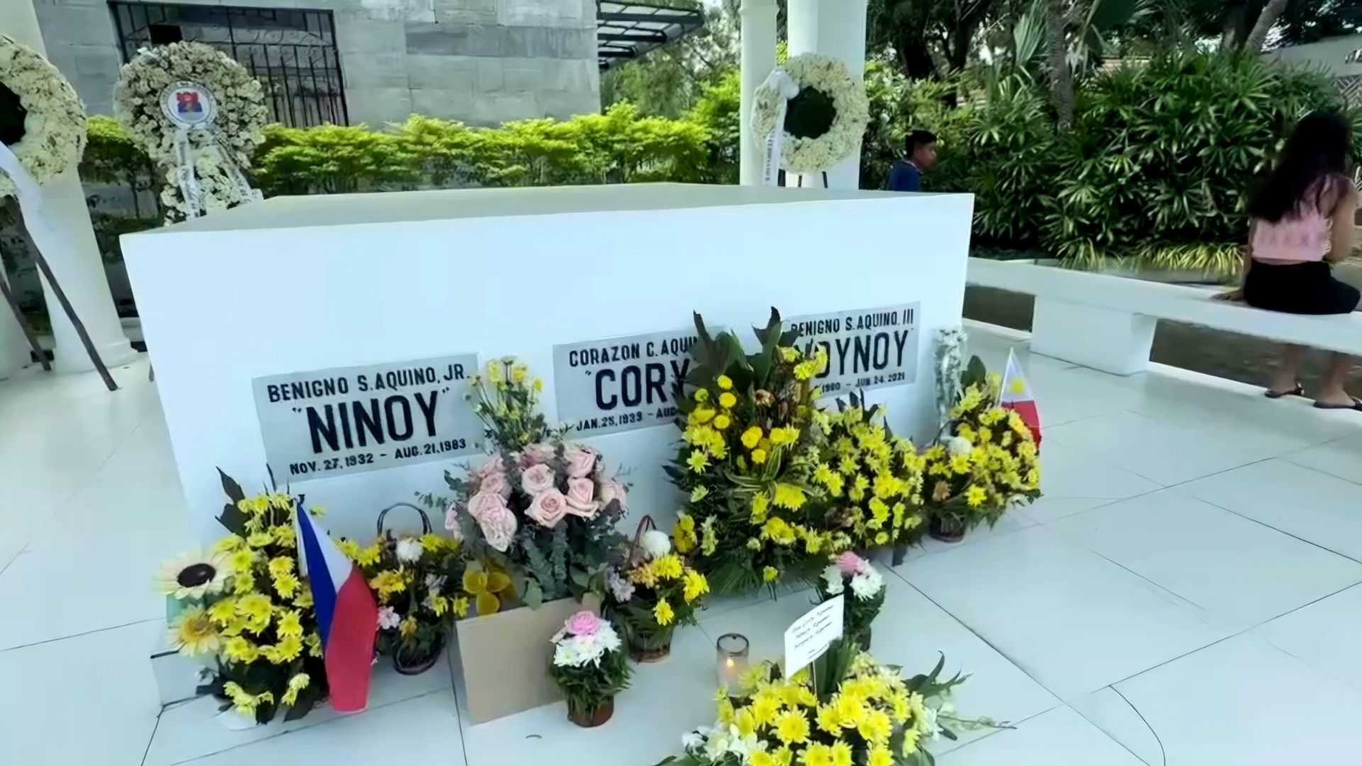 PBBM, supporters bring flowers, light candles at Aquino family mausoleum in Parañaque