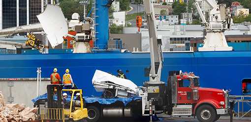 Presumed human remains and shattered Titanic submersible returned to shore